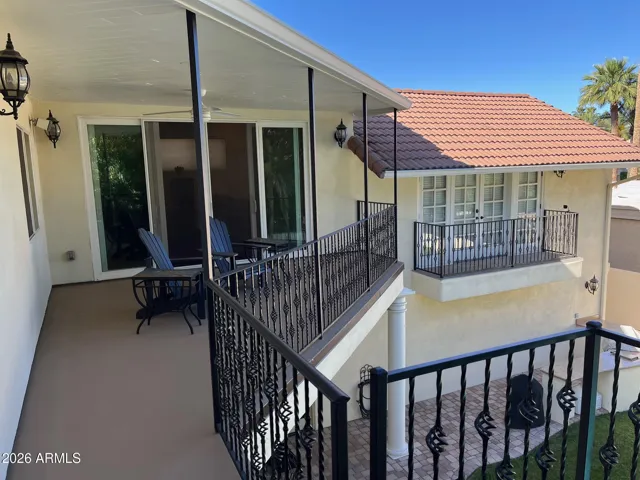 Upper, covered balcony overlooking beautiful backyard