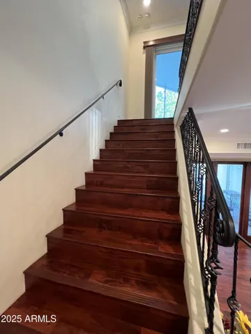 Staircase to upper level primary ensuite bedroom
