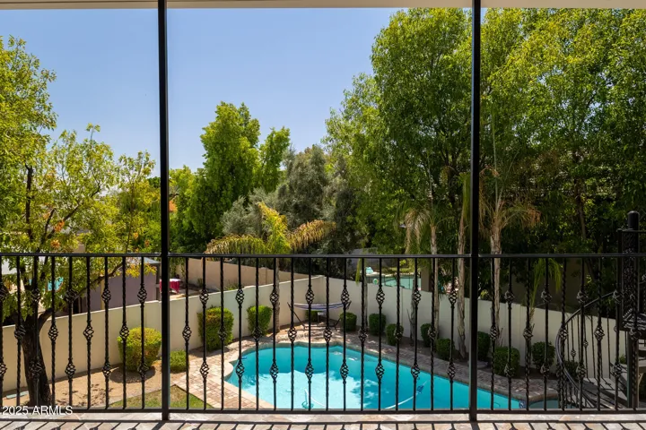 Upper, covered balcony overlooking beautiful backyard