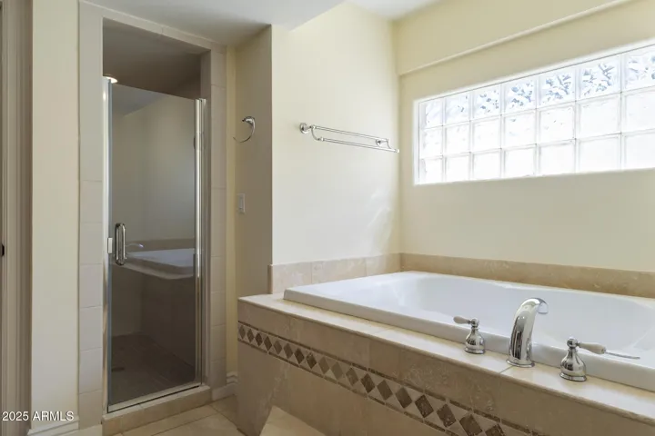 1st floor primary ensuite bathroom with separate tub and shower