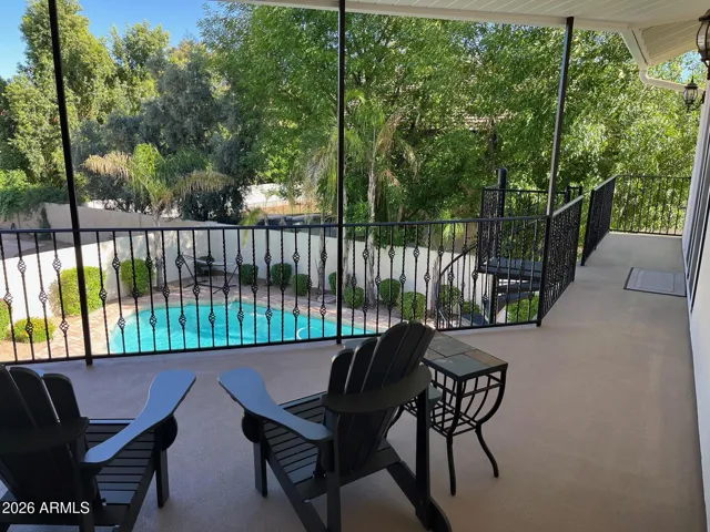 Upper, covered balcony overlooking beautiful backyard