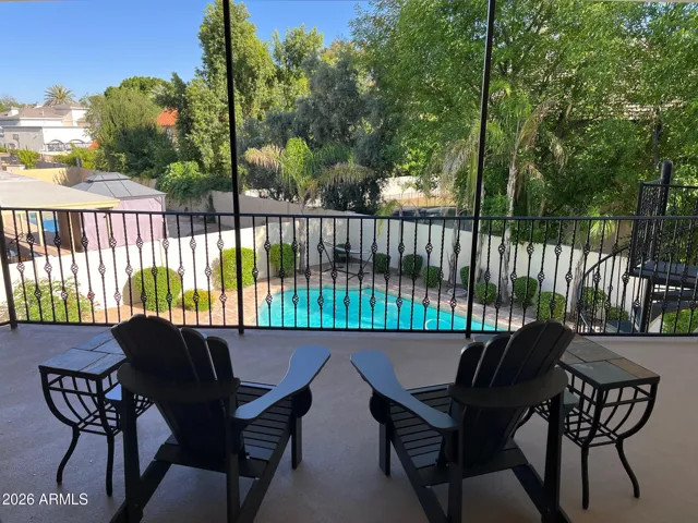 Upper, covered balcony overlooking beautiful backyard