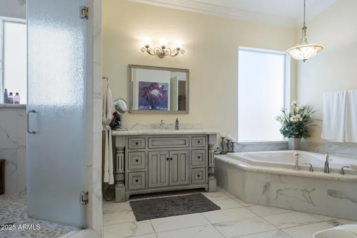 Upper level primary ensuite bathroom with jetted tub and separate shower