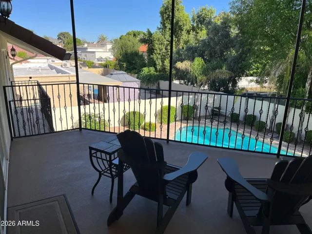 Upper, covered balcony overlooking beautiful backyard