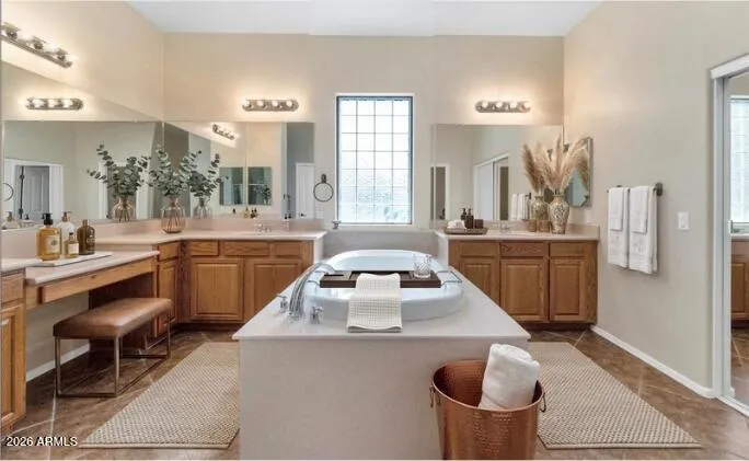 Wind down in your this primary bathroom with soaking tub, and separate vanities.