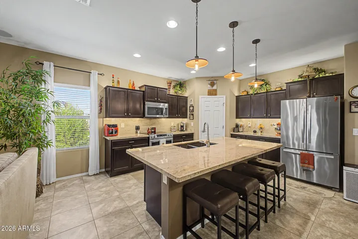 Stunning Kitchen with SS appliances, pendant lighting, walk in pantry, and expanded island