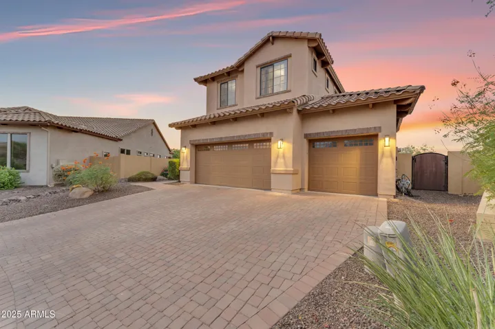 3 Car side by side garage offering a wide pavered driveway