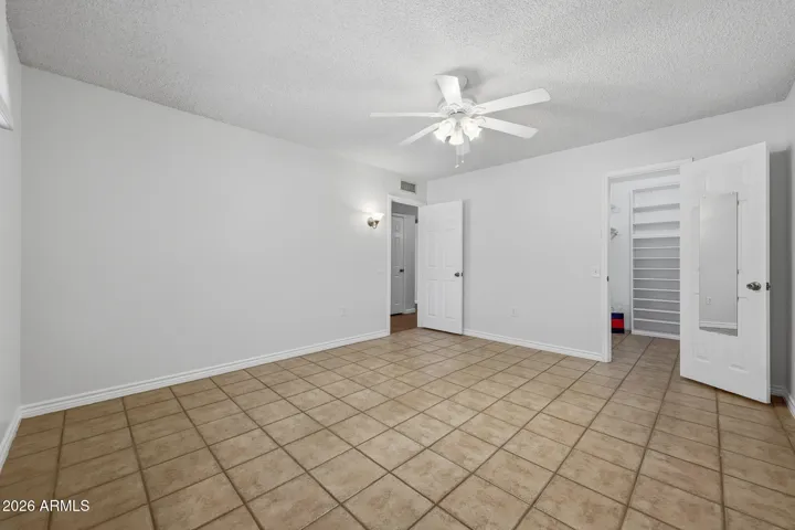 The Guest room is located in the front of the home. It is unusually large, tiled and has a walk in closet space.
