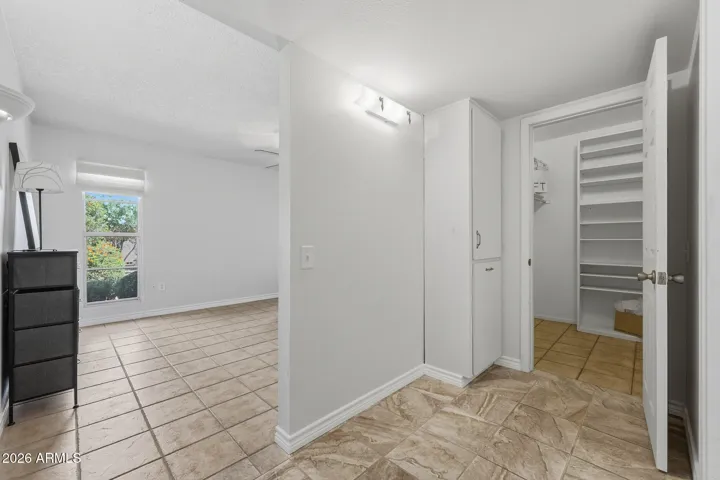 Within the Primary Bedroom is a dressing area, linen storage just outside the walk in closet.