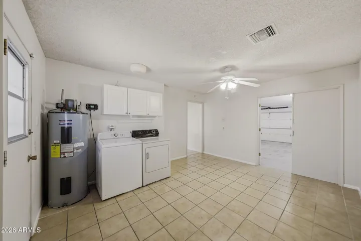Approximently a 12' x 15' Laundry Room can serve as an Office or Hobby Room too. Double doors allow easy access to the Garage. As well aa door to the Backyard and Kitchen.