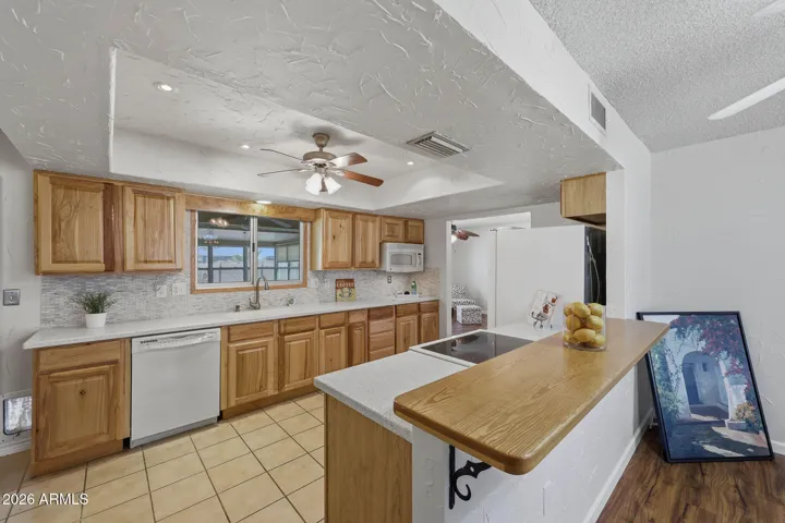 The Kitchen has a bar counter and drop in electric range, This allows for an open space to the Living Room.