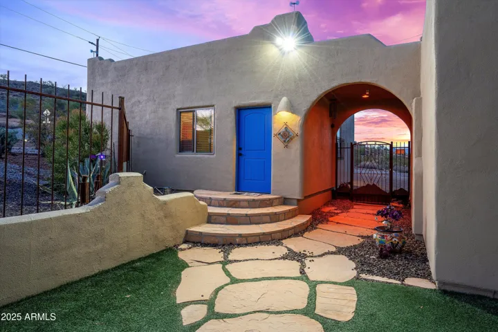 Fenced in front yard and entrance to detached garage