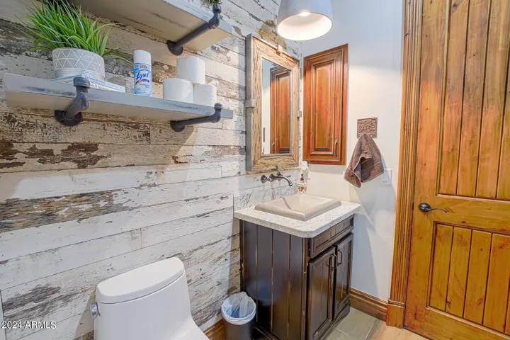 Guest bath with barnwood wall, concrete light fixture and matching sink