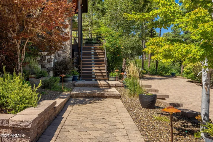 Stunning landscaping and matured trees welcome you home