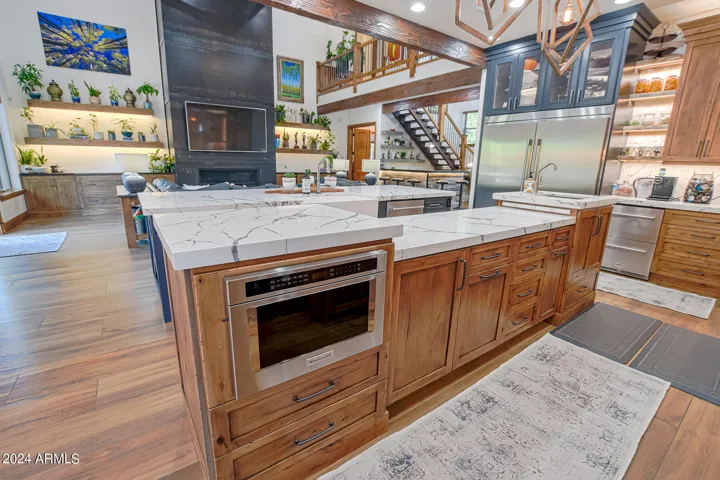 Custom prep island with Kitchenaid pop up stand next to built in drawer microwave