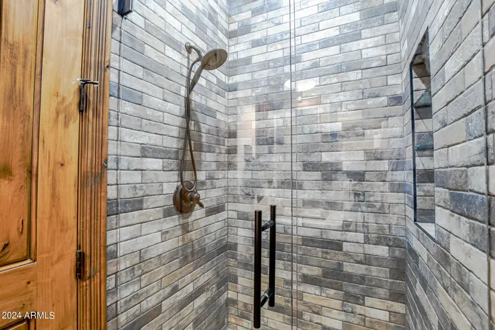 Beautiful brick tile to the ceiling in guest bathroom