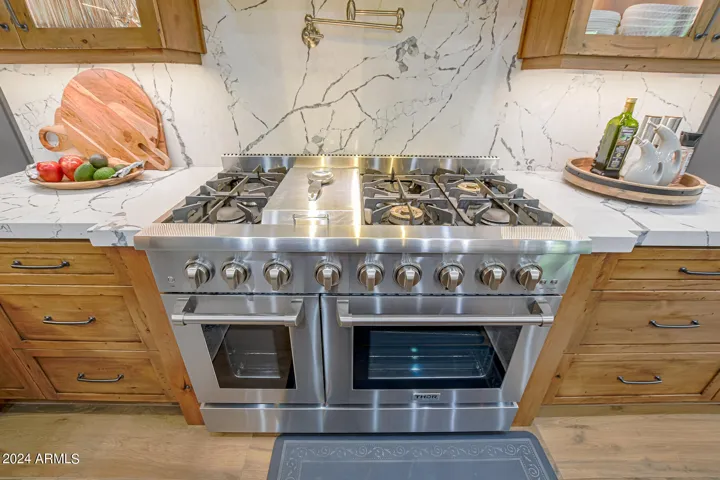 Full slab quartz backsplash with pot filler for convenience