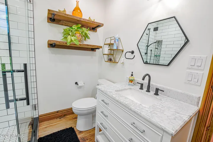 Vinyl plank flooring adds a touch of warmth to this en suite