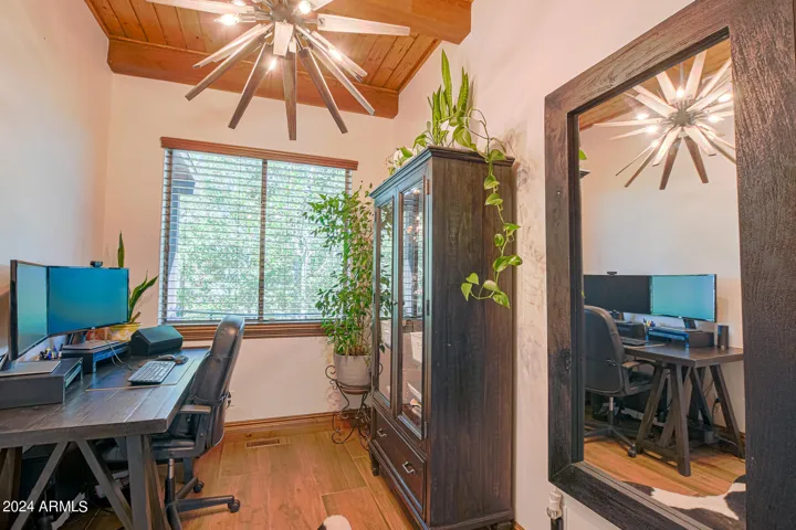 French doors open to this entry to the owner suite. currently used as a workspace, could be a sitting area, work out room or Zen area!
