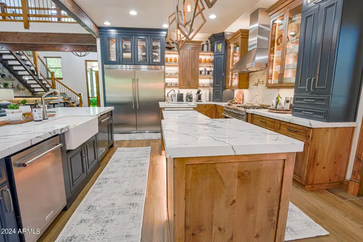 Every chefs dream! Large farmhouse sink and two dishwashers with plenty of seating to enjoy your guest while you prep!