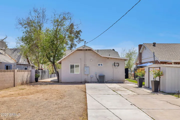 Rear Exterior with Yard and Parking Area