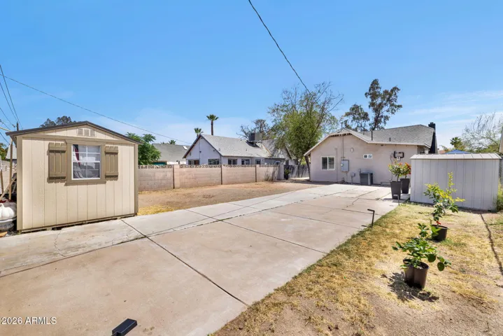 Rear Yard with Driveway and 2 Detached Storage units