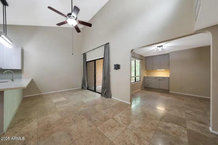 Large dining space with soaring vaulted ceiling and tons of natural light