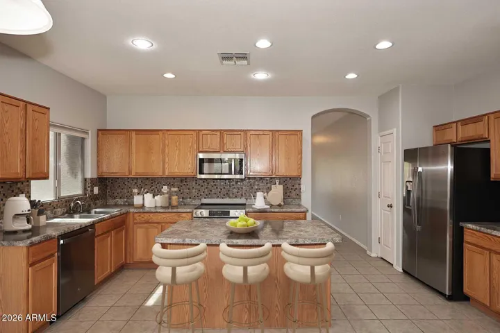 Kitchen has breakfast bar (virtually staged)