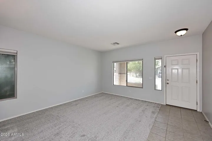 Living room overlooks front yard features NEW carpet (4/26)
