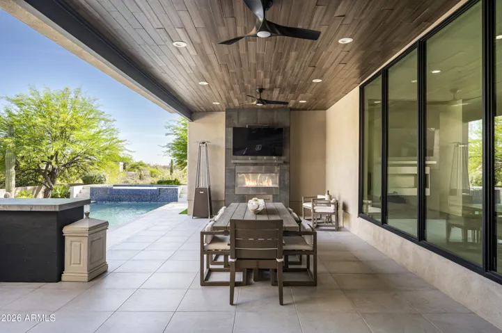 Covered patio facing outdoor fireplace