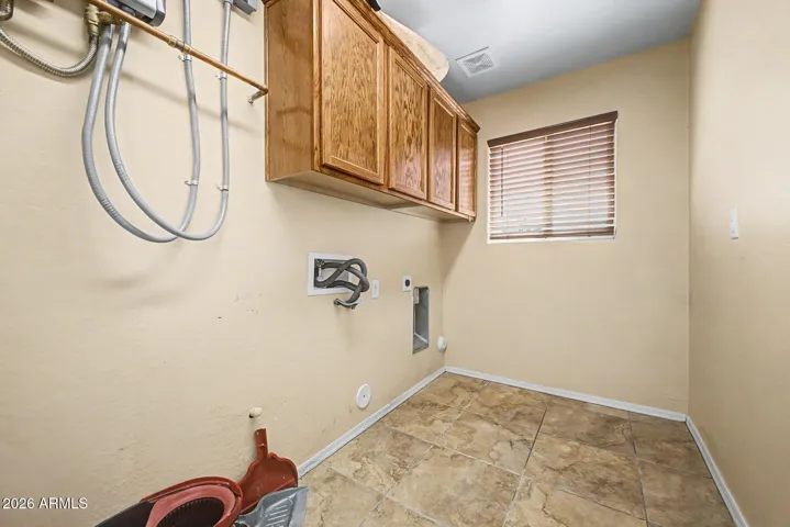 Inside Laundry room with a tankless water heater!