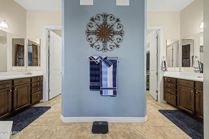 Primary bath features separate sink areas and dual entry shower