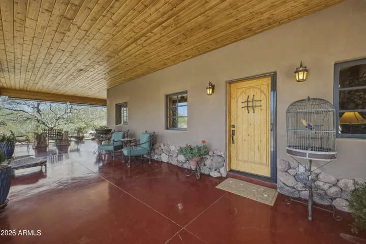 Large outdoor porch wraps around the home.