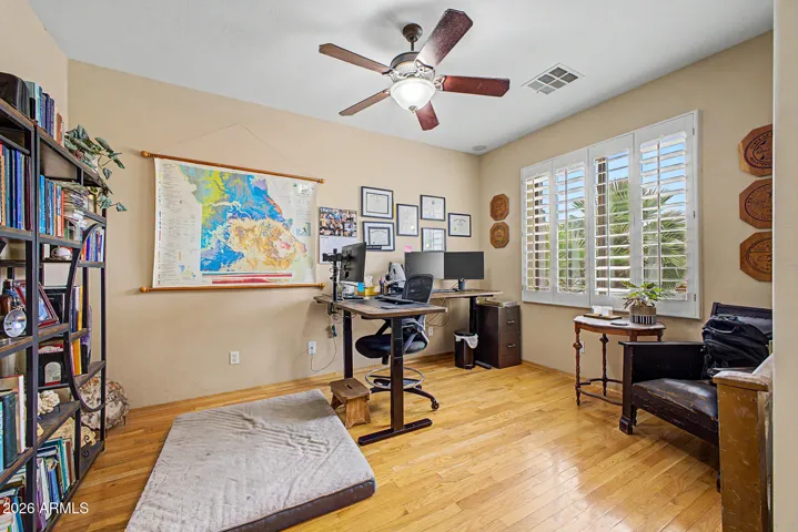 Adjacent front door is den with real wood floors offers a polished, flexible space for a home office or quiet retreat.