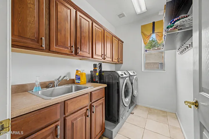 pacious, upgraded laundry room offers a mop sink, abundant cabinetry, and included washer/dryer for turnkey living.