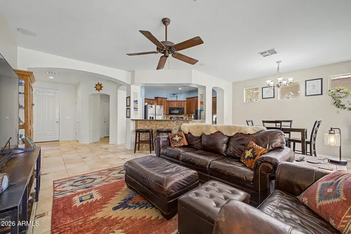 Step into the great room with yard access, breakfast bar seating to the gourmet kitchen, built-in speakers, and upgraded low-maintenance tile flooring.