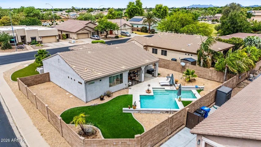 Expansive corner cul-de-sac lot offers exceptional privacy with a large backyard, dual side yards, lush turf front & back, and a resort-style pool with water feature.