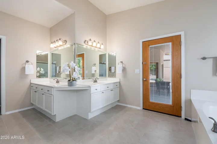 Primary bathroom with door out to covered patio
