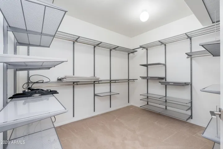 Primary bedroom walk-in closet