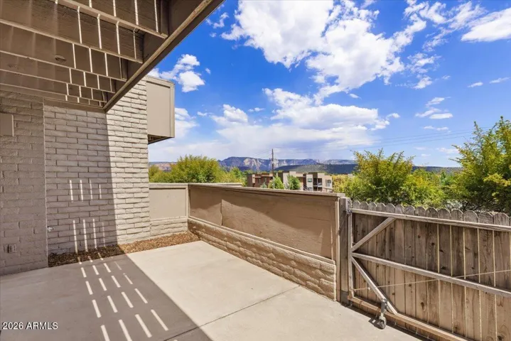 Versatile, partially covered 1st floor patio with gate to the common area.