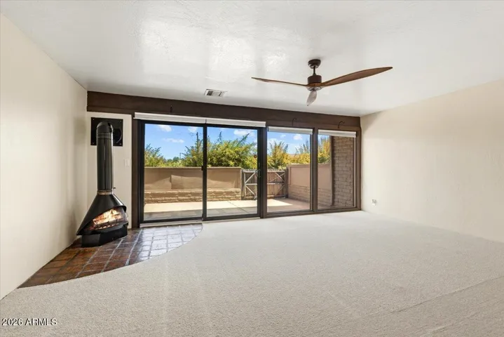 Relax with friends and family in the pleasant Living Room , full of natural light from the home's 1st floor patio. [photo with virtually staged furnishings]