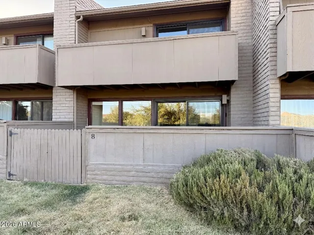 South-facing side of the home, featuring 1st floor Patio and Upper Deck off the Primary Suite.