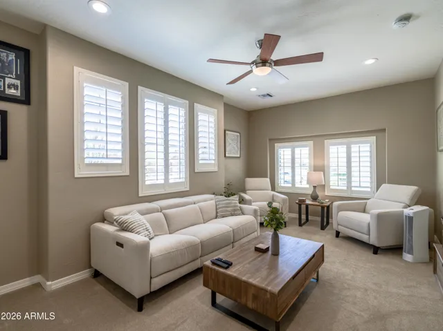 Secondary living space with shutters, ceiling, fan, and recessed lighting