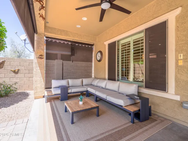 Covered back patio with retractable shades to block the evening sun