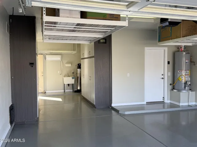 Garage Cabinets, water, treatment system, utility sink, and overhead storage racks