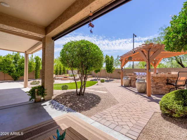 Back patio opens up to a backyard that is an entertainers paradise