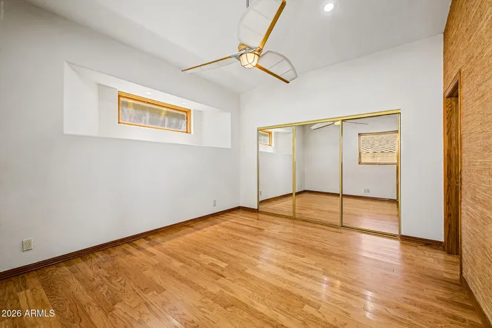 Pella Fixed Window with Built-in Blinds between the glass | Engineered Wood Flooring |Closet with 3-Panel Mirrored Doors