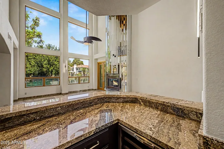 Granite countertop with tile backsplash | Beverage refrigerator