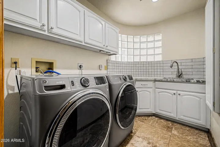 Upper and Lower Cabinetry | Wall-mounted Ironing Board | Updated Granite Countertops with Tile Backsplash | Deep Soaking Sink with updated faucet | 2026 Refinished Cabinetry