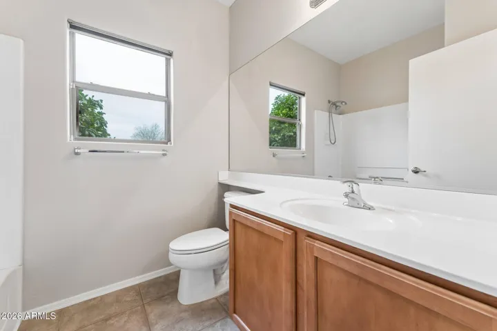Hallway bathroom with tub and shower.